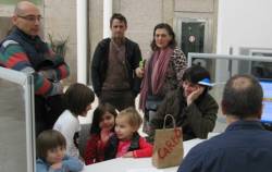 Representants de l'AMPA i alumnes de l'escola Annexa Joan Puigbert durant l'entrega de la carta i el sac de carbó